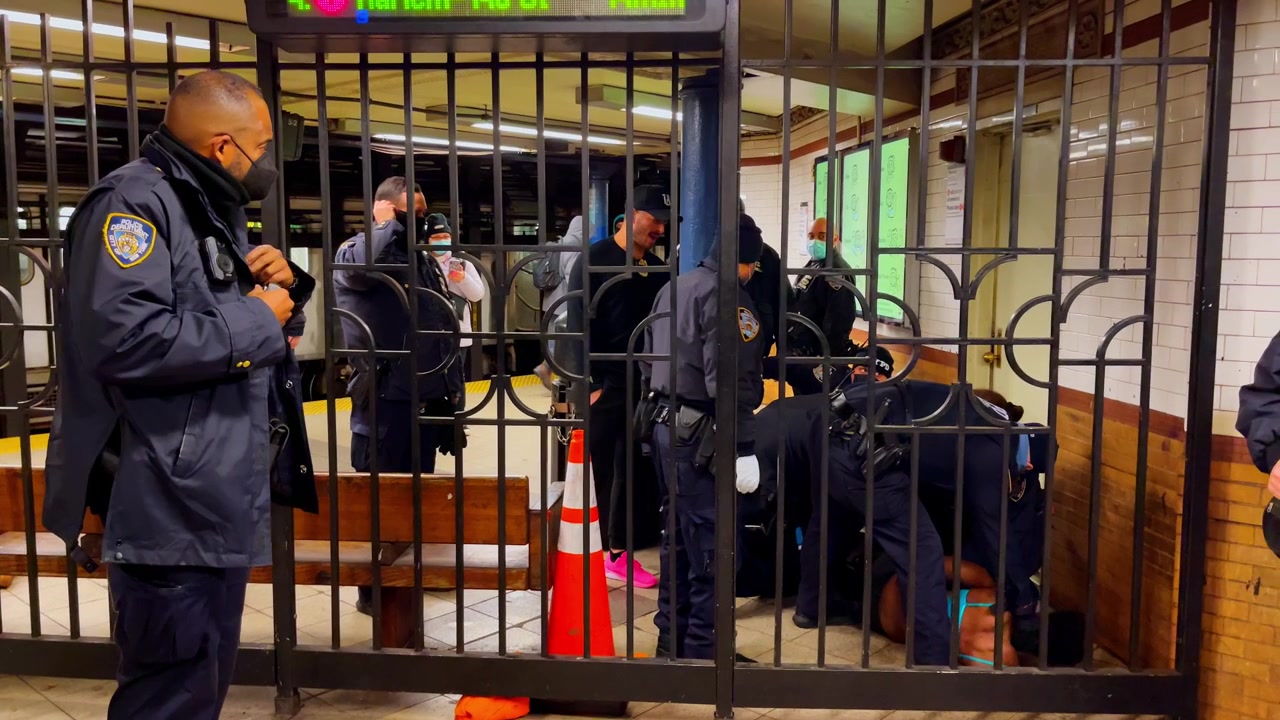 New York, USA, 9 March 2022: NYPD officers responding at Harlem subway platform. NYPD officers gather by gated subway platform at 125th Street station in Harlem.
