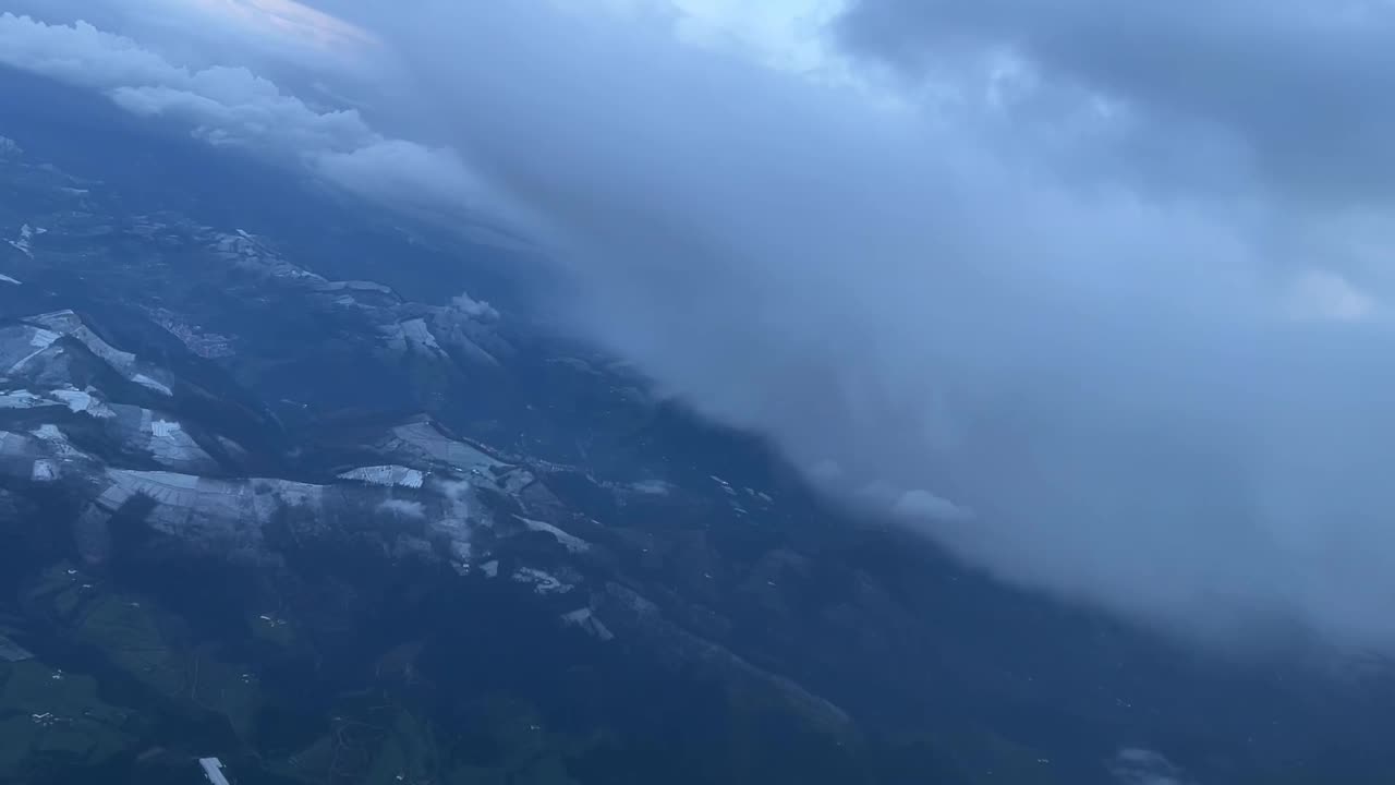 Cockpit view of some snow clouds in a left turn toward Bilbao’s airport in a cold winter day with snow falling