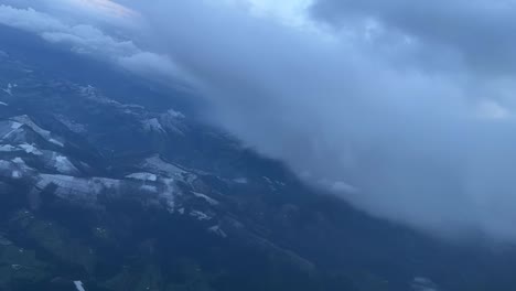 cockpit view of some snow clouds in a left turn toward bilbao’s airport in a cold winter day with snow falling