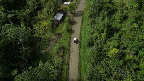 vehicle full of passengers travelling offroad through virgin rainforest in the highlands of new guinea