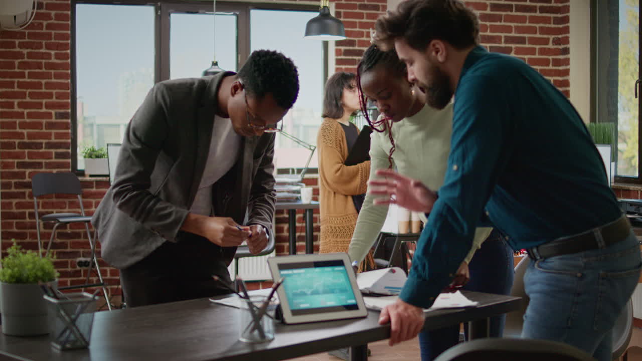 Diverse team of colleagues working on business report