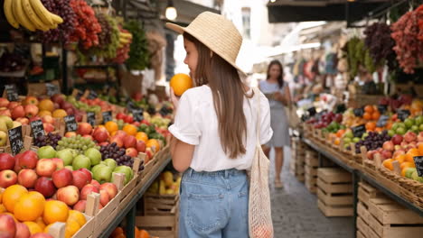 young girl shopping for fresh fruit at an outdoor market