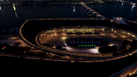 nighttime aerial view of a modern urban park with water feature and fountains