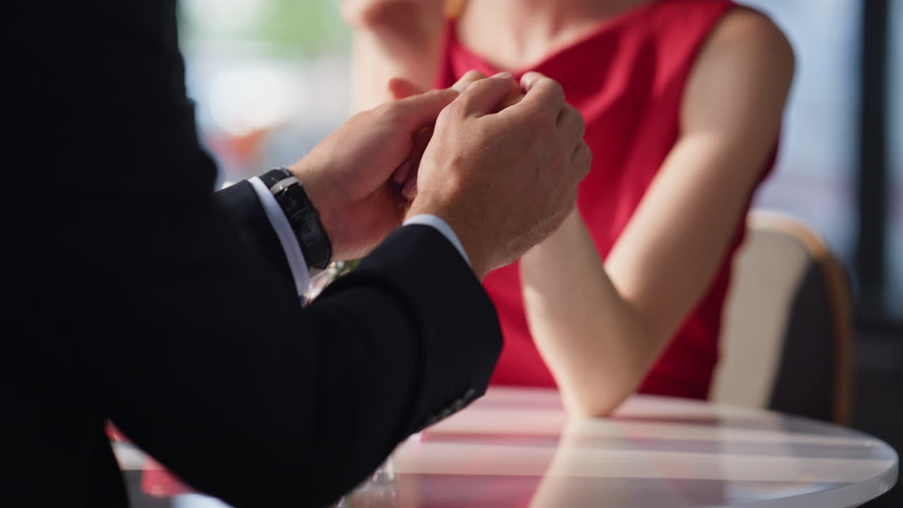 Loving wife admiring husband enjoying romantic date in cozy cafeteria closeup