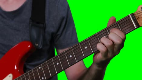 mid section of male musician playing guitar