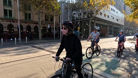 cyclists and trams sharing a busy street