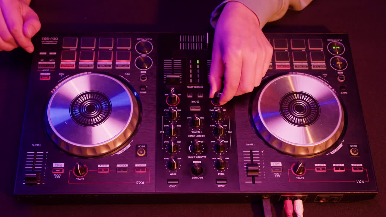 DJ with headphones and sunglasses playing music on festival in night club. Techno musician performing at nightclub for concert crowd of people, city bar.
