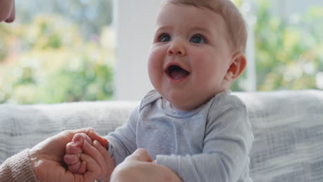 happy-young-mother-playing-with-baby-at-home-smiling-enjoying-motherhood-playfully-caring-for-cute-infant-4k