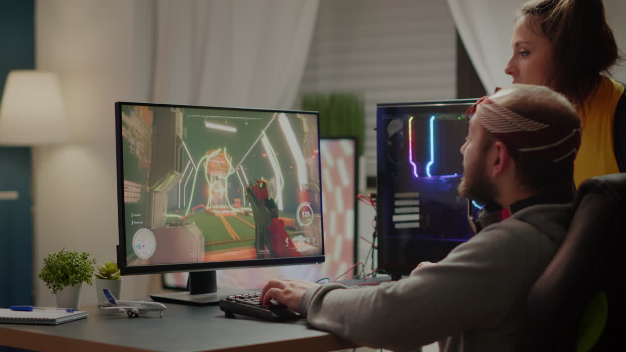 Couple of gamers playing first person shooter videogame