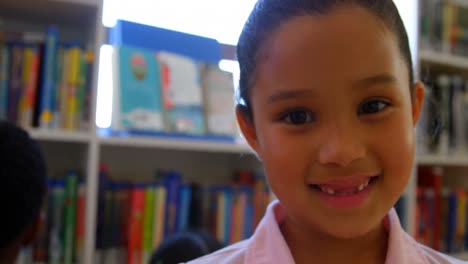 schoolgirl standing in school library 4k