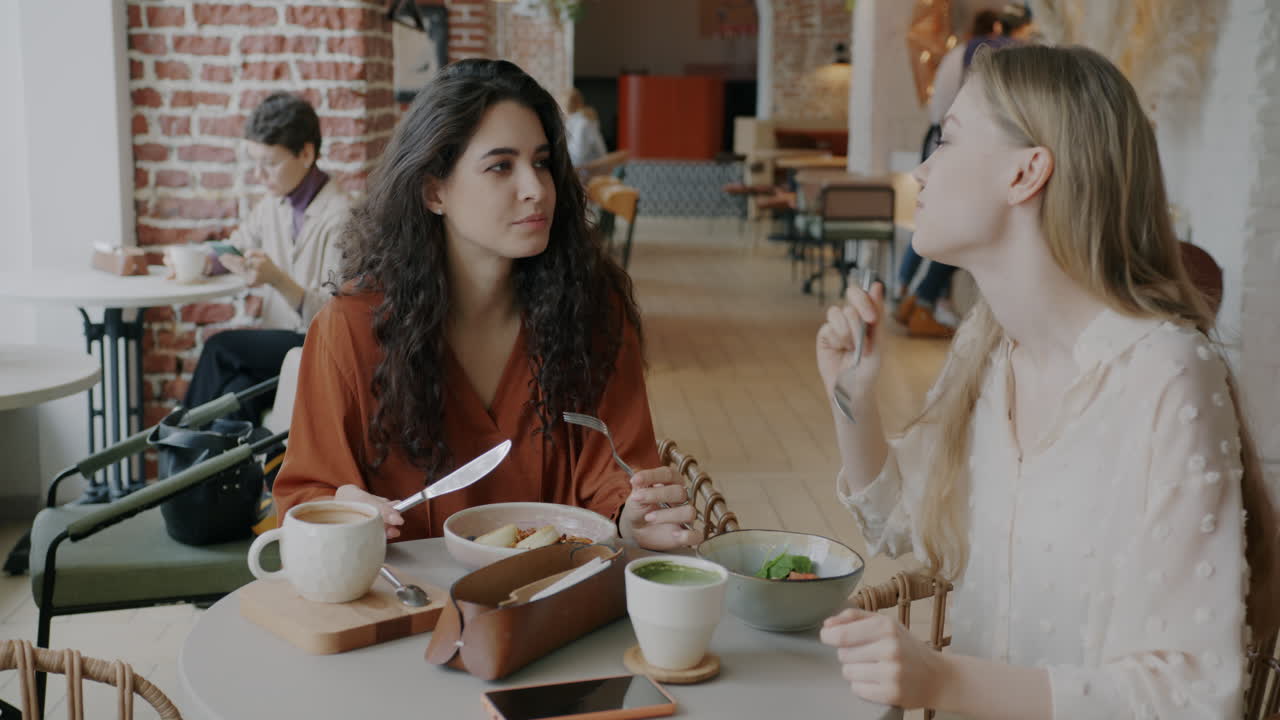 Two friends enjoying a meal in a cafe