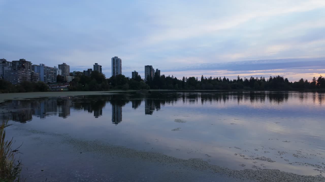 Gimbal wide panning shot of Lost Lagoon during dusk at Stanley Park in Vancouver, British Columbia, Canada. 4K