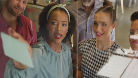happy diverse business people discussing work during meeting at office
