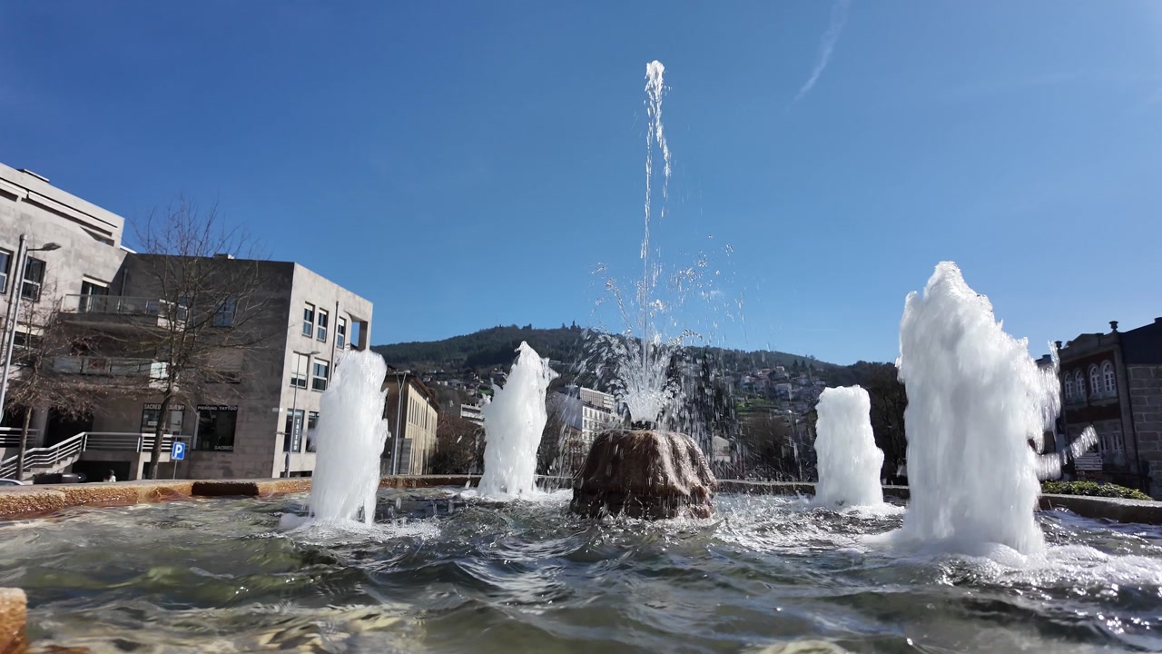 Guimaraes city monuments fresh water fountain in slow motion. Gimbal shot.