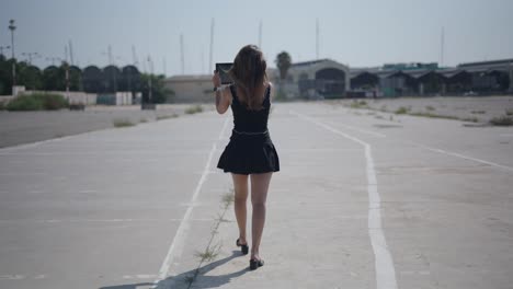 woman walking on an empty road