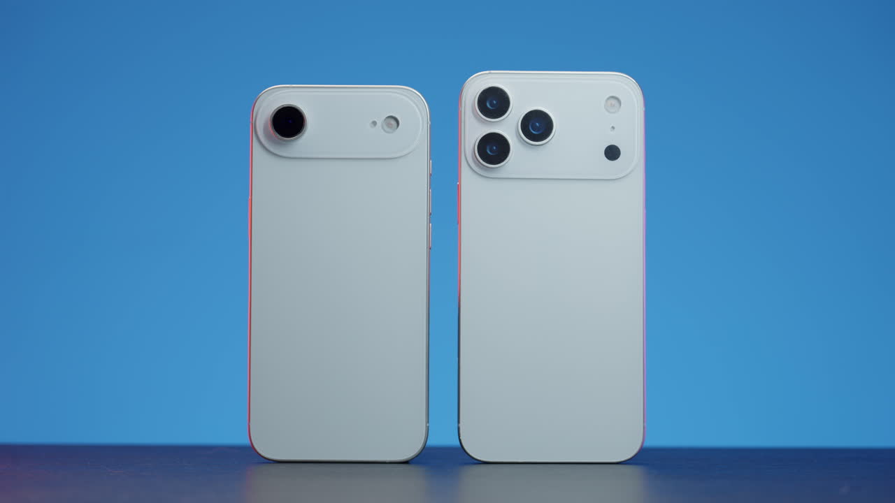 Two Smartphones with Different Camera Setups on a Blue Background