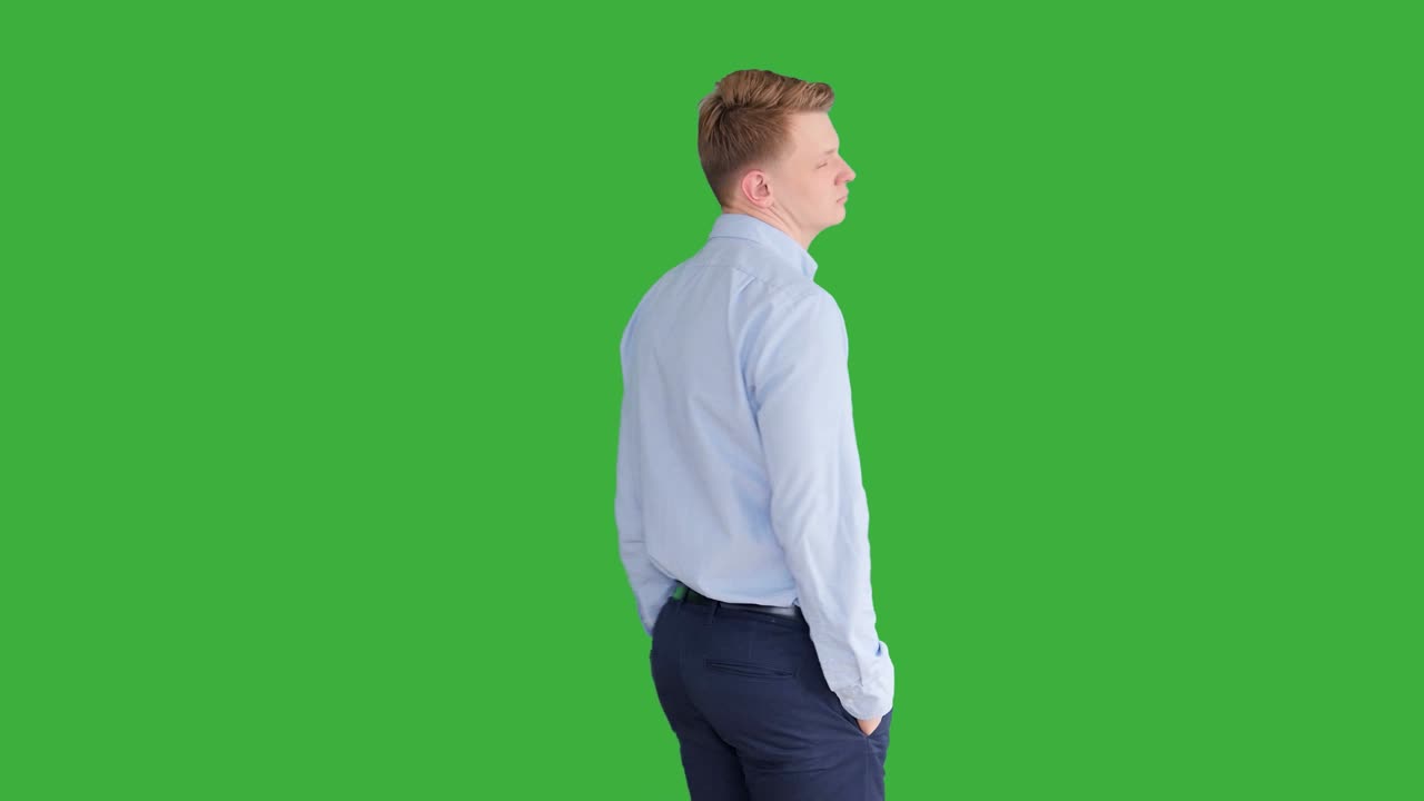 Young Caucasian Man Standing against Green Screen Background. Male Person Isolated on Chroma Key. Casual Business Professional Portrait