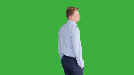 young caucasian man standing against green screen background. male person isolated on chroma key. casual business professional portrait