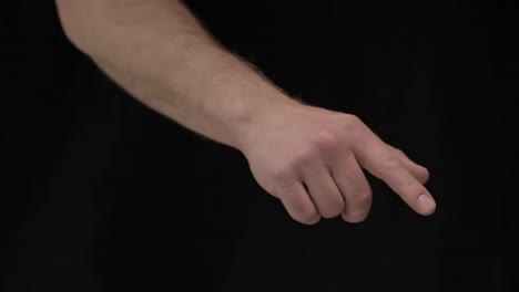 Male-hands-on-a-black-background