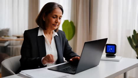 businesswoman working on laptop in home office