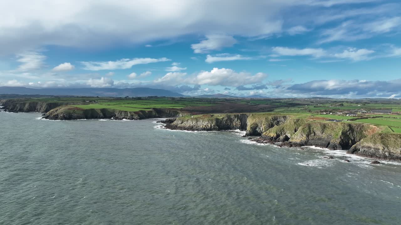 Drone seascapes Ireland view East along The Copper Coast Waterford where the land meets sea on an autumn day