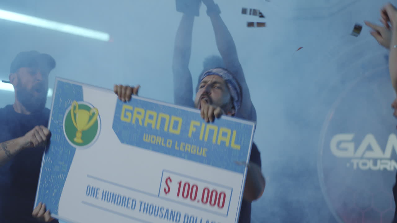 Gaming Tournament Team Celebrating their Victory Medium Shot of a Gaming Tournament Team Holding their Prize while Celebrating their Victory