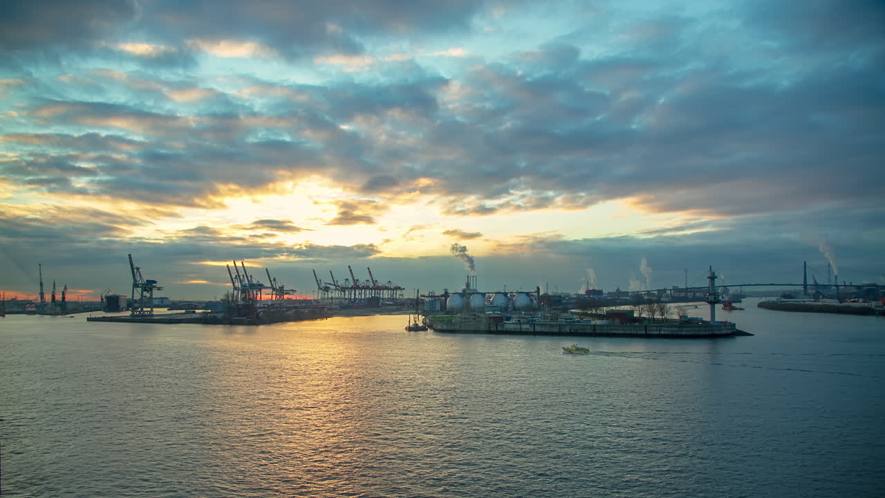 wonderful time lapse long shot of a sunrise in the port of Hamburg with ships and clouds
