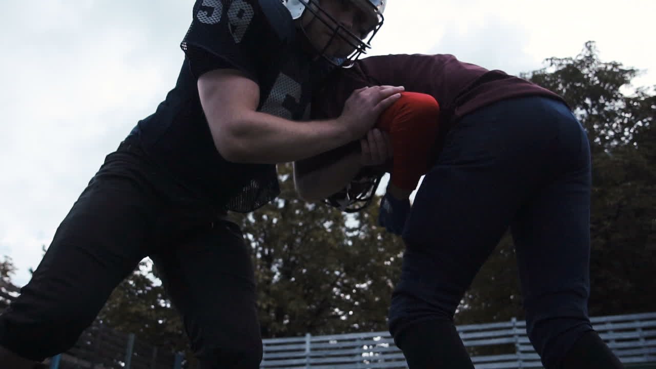 American Football Players Tackling
