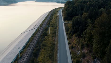 aerial shot of couple of bikers riding together next to the lake