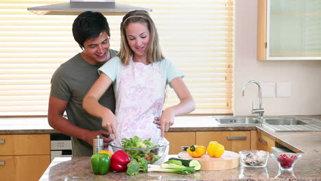 a woman mixing a salad