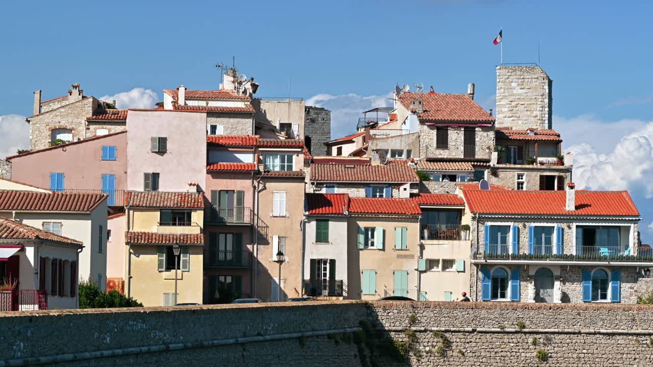 Mediterranean sea coast of Antibes, France. Ancient walls, buildings and cars