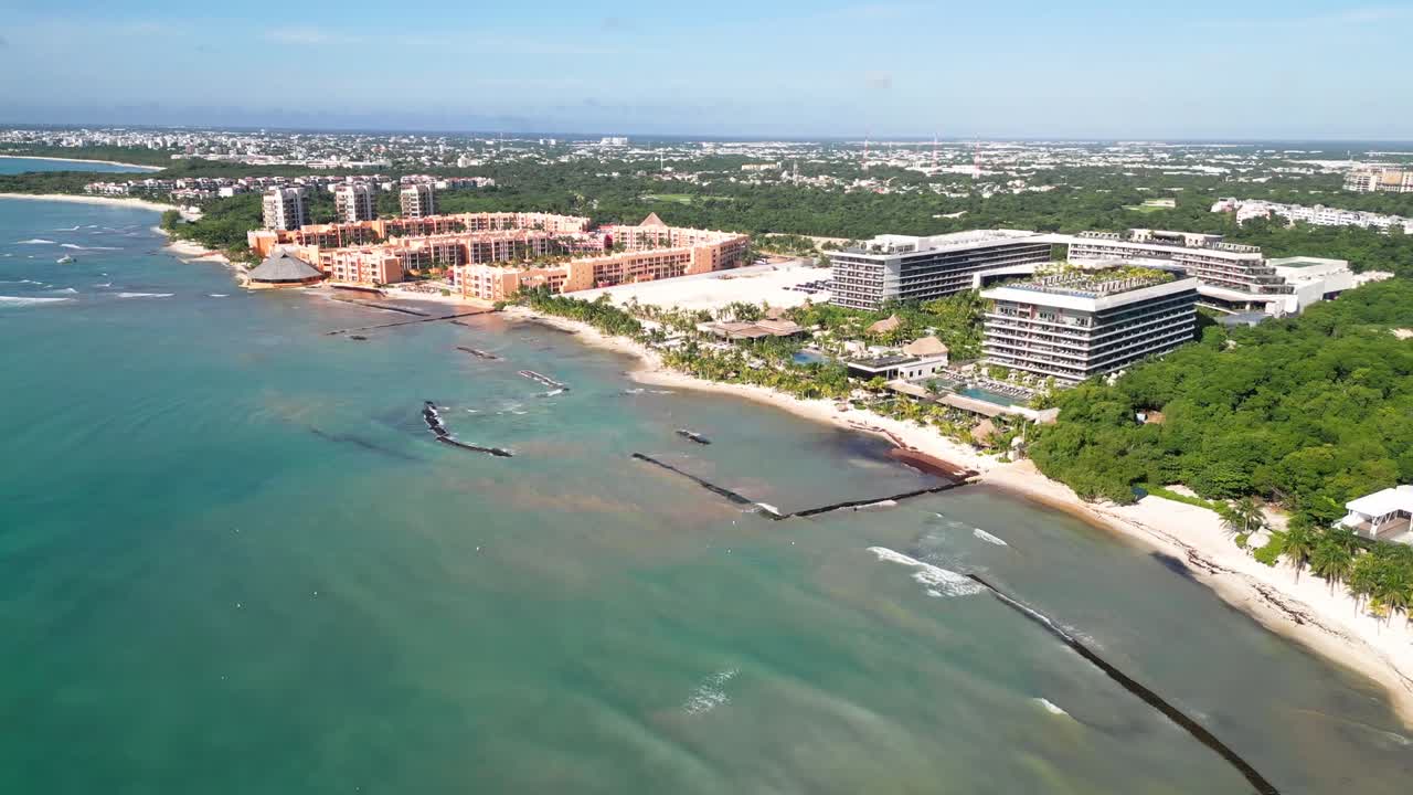 Aerial view of luxury coastline resort with calm blue water and sandy beaches. Shot along the Mexican Caribbean near Playa del Carmen