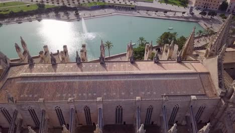 scenic aerial view of cathedral of santa maria of palma with pool and fountain