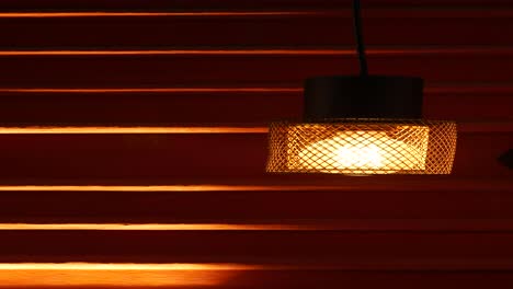 stylish hanging lamp against a textured red wall