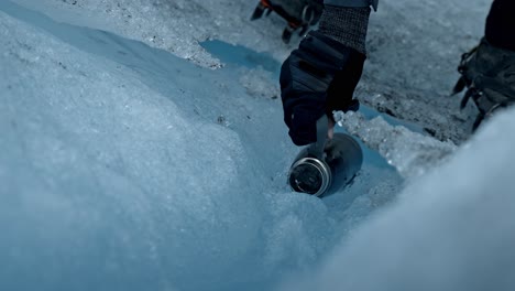 Climber-filling-a-water-bottle-in-The-Perito-Moreno-Glacier,-the-most-iconic-glacier-in-the-world