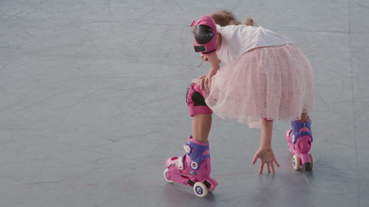 niña aprendiendo a patinar en el skatepark
