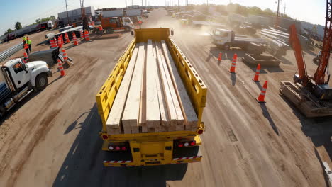 loading lumber on a truck at a construction yard