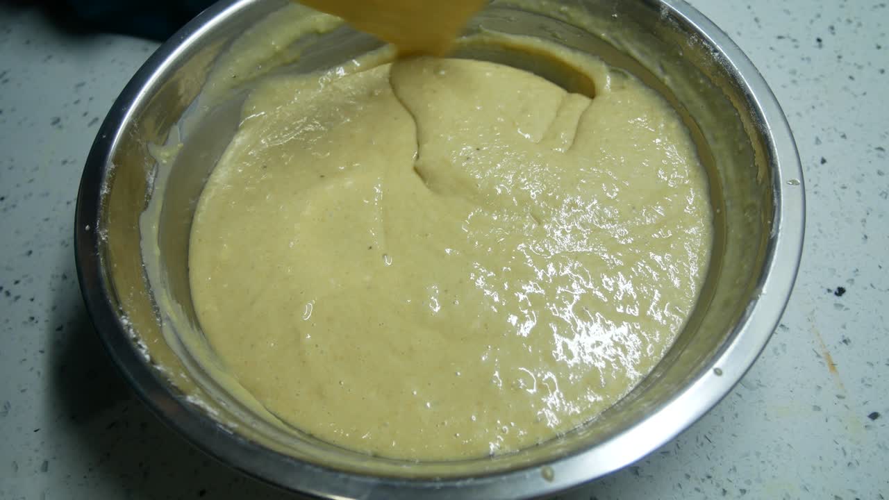 Mix the flour and other ingredients until well blended manually. It is the early stage of the baking bread and cakes process. This will take some time to get a good mix.