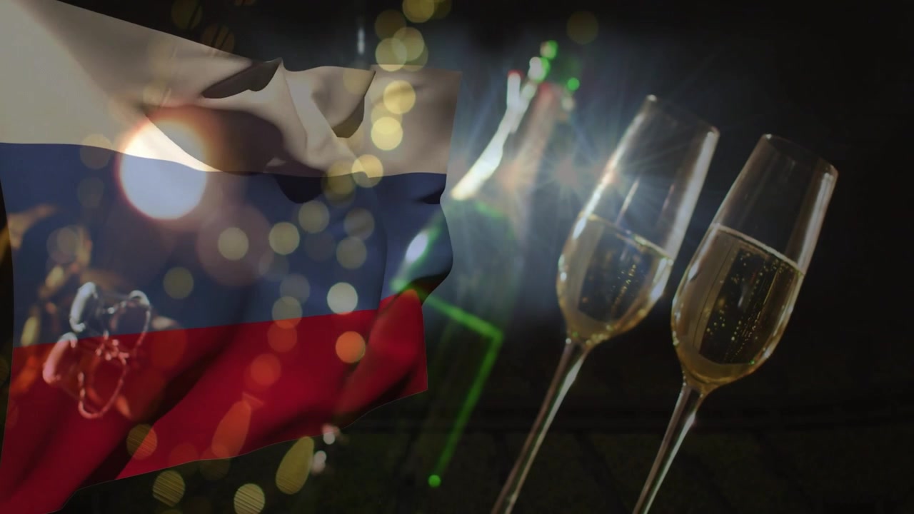 Efecto bokeh comenzando, bandera tricolor ondeando a la izquierda mientras se muestran botella y copas, brillando, indicando fiesta.