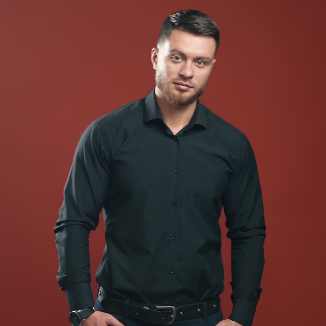 Handsome brunette man. Businessman with attractive appearance in black shirt on bright background. Business concept.
