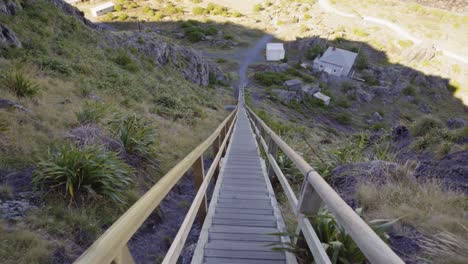 Perspective-shot-descending-a-tall-wooden-staircase