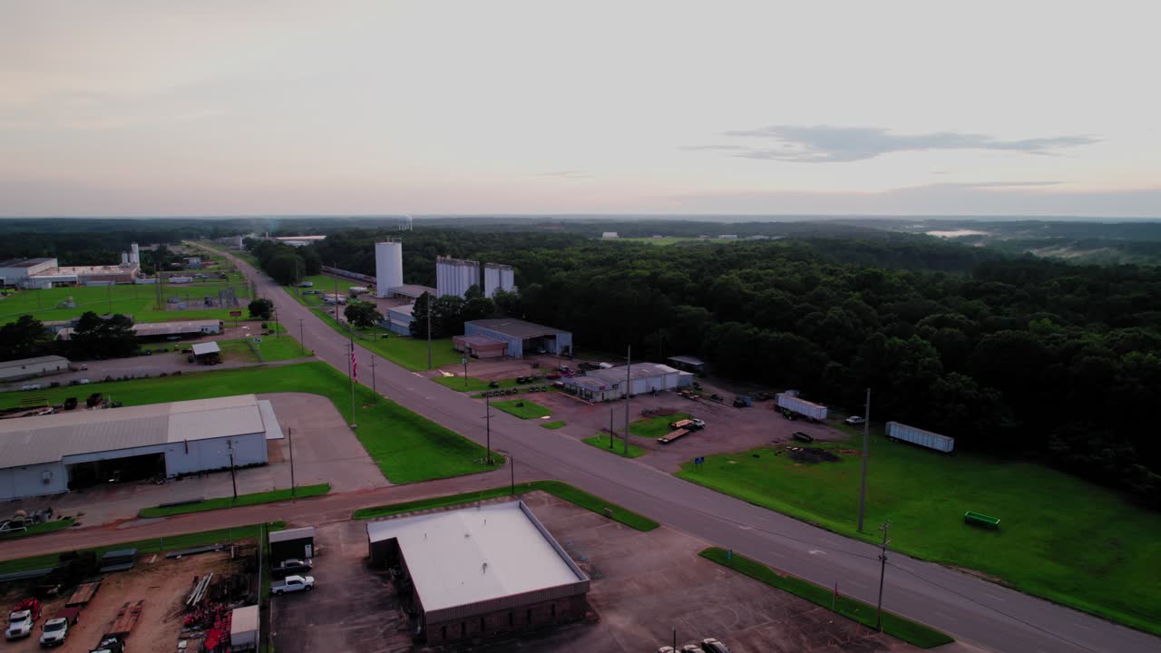 Wide Aerial View of Grain Silos and Industrial Buildings in Rural Alabama Landscape
