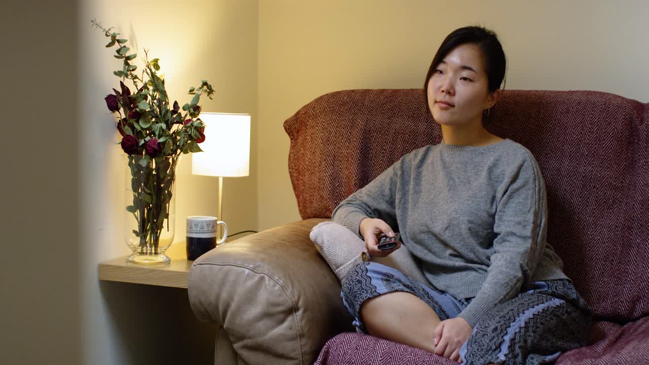 Asian Woman Enjoying TV during Self-Isolation