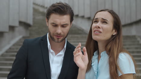 coworkers looking up on street