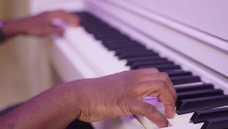 person playing a white piano