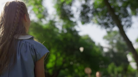 Closeup-joyful-girl-hit-shuttlecock-in-park.-Brother-failed-return-birdie.