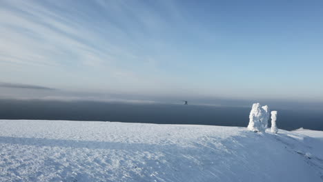 helicopter over snowy mountain peaks