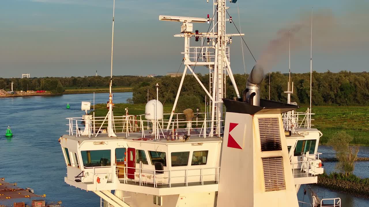 Cargo Ship's Bridge and Smokestack on a River