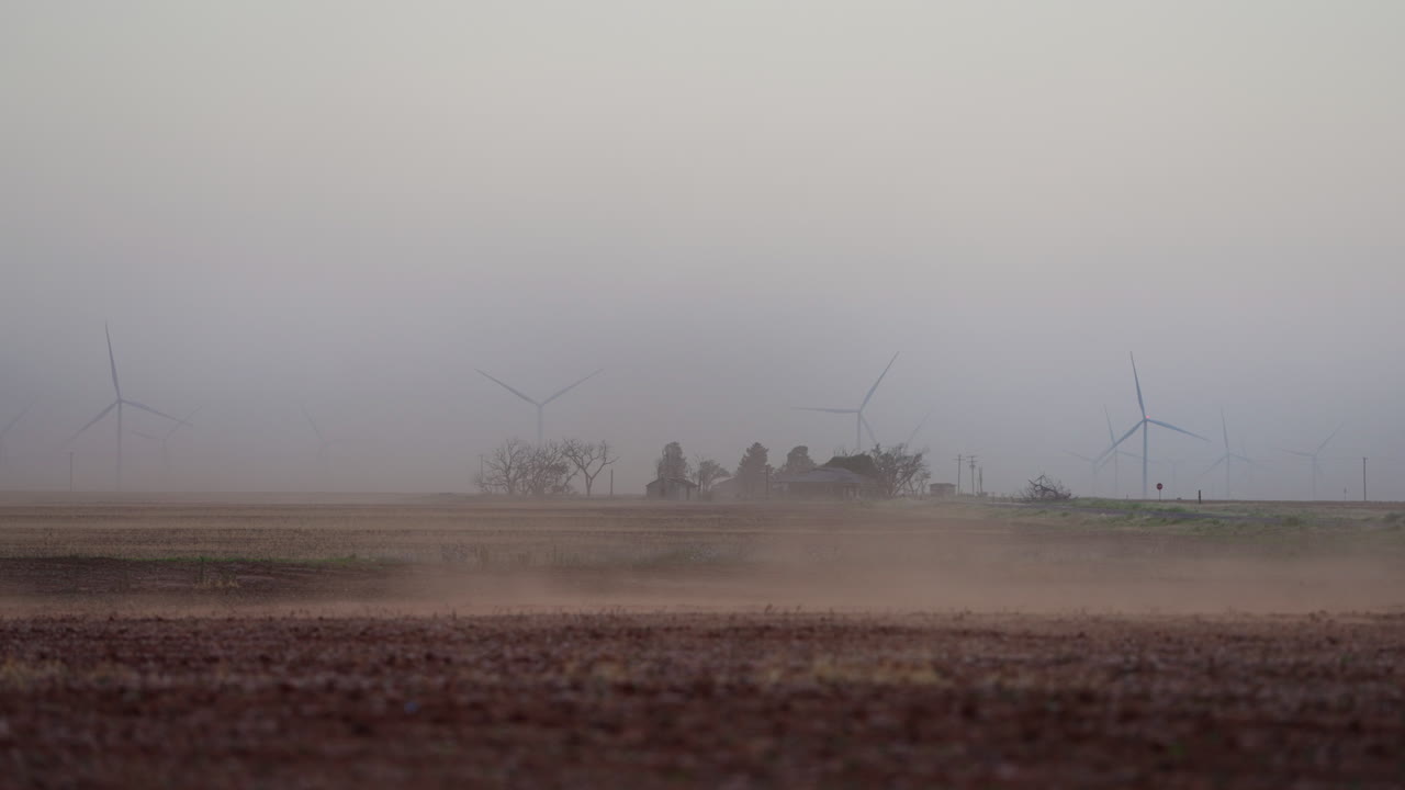 Dust Blowing Across Farmland with Wind Turbines