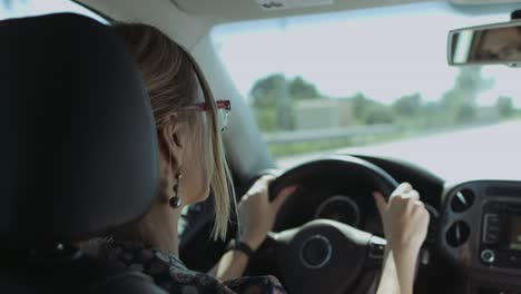 positive woman driving car on interstate highway